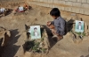 A Yemeni child prays by the graves of students who were killed by a Saudi-led coalition airstrike at a cemetery in Saada, Yemen, on September 4, 2018.